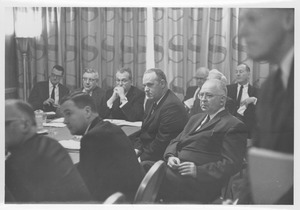 Alden C. Brett sitting with a group of men
