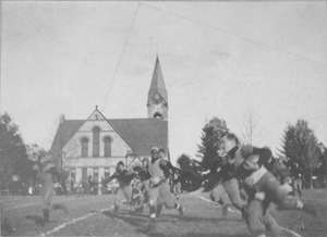 George R. Cobb running with football