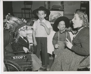 Connie Boswell with young clients in costume eating turkey