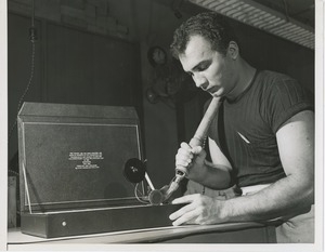 A man works on the box for the 1955 President's Committee on Employment of the Physically Handicapped Award