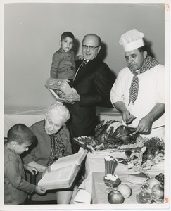 Dr. Salvatore DiMichael with chef and young clients at Thanksgiving celebration