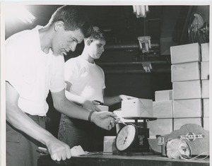Young men with cerebral palsy performing packaging job for work evaluation