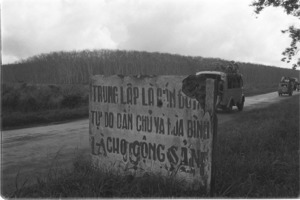 Rubber plantation poisoned by U.S. chemical spray, in background.