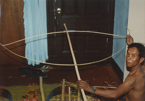 Kite Making: Soeun Tim attaches the two splits to the spine of the kite, 1987