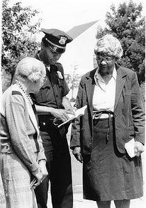 Unidentified Boston police officer with two unidentified elderly women