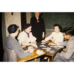 Adults playing a game of bridge