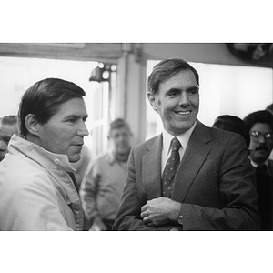 Boston Mayor Raymond Flynn stands next to a man at an event