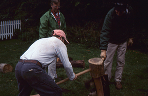 Hopkins Forest Fall Festival, 2000. Making white ash shakes with maul and froe. Some identifications left to right: Lauren Stevens in light green jacket and Henry "Hank" Flynt, Jr. in dark green jacket.