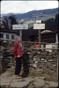 Sandi Sommer in front of sign posts in Junbesi