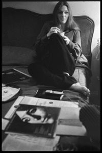 Judy Collins, seated on a bed at the Beverley Hills Hotel