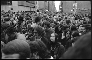 Protesters crowd the streets near Bryant Park for the Vietnam Moratorium demonstrations, sign reads 'Support the National Liberation Front'