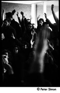 Crowd raising their hands at the demonstration: white student support for Brandeis University African American student protest
