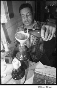 Karmu (Edgar Warner) mixing herbal medicine