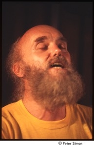 Ram Dass singing, on stage with Amazing Grace