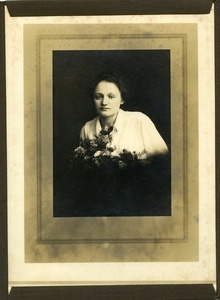 Polish American woman with bouquet of flowers: half-length studio portrait