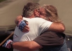 Vietnam veterans embrace at the dedication ceremony for the Vietnam War memorial