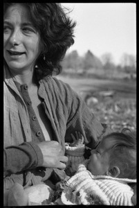 Nina Keller preparing to feed her baby, Montague Farm Commune