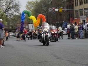 Contingent of motorcyclists under a rainbow array of balloons: Pride Parade; Main Street, Northampton, Mass.