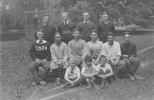 Class of 1924 members posing with three young boys