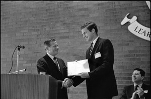 Governor Volpe and Elliot Richardson at Boston University: John Volpe shaking hands with an unidentified man