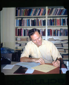 Professor John Neumann writing in his office