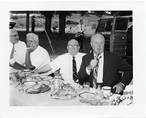 Mayor John F. Collins speaking at an outdoor luncheon