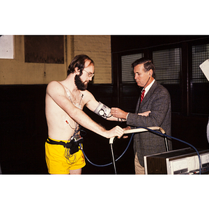 Doctor monitoring a man taking a cardiac stress test