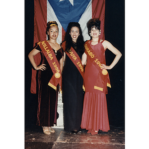 Yaritza Gonzalez, Damaris Padilla, and Chamely Toro in front of a Puerto Rican flag at the Festival Puertorriqueño