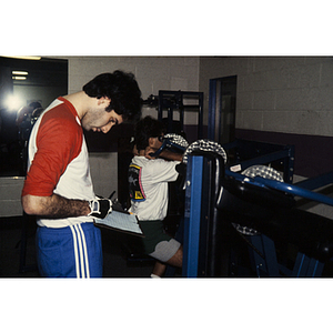 Man writes on a clipboard at a gym