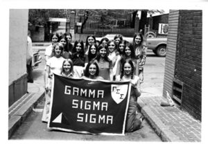 Group photograph of the members of the Suffolk University's Gamma Sigma Sigma Sorority holding a banner, 1972