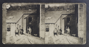 Miners standing outside shaft