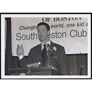 A man speaking from the podium at a St. Patrick's Day Luncheon