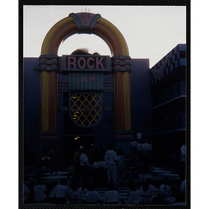 Children and adults gather outside the Rock Inn attraction at Walt Disney World