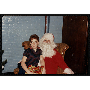 A girl poses with Santa Claus