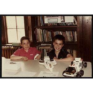 A Boy and a girl sitting at a table with their project on NASA and astronauts