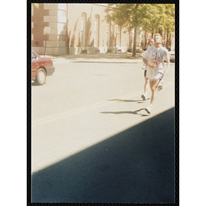 A boy and girl run in the Battle of Bunker Hill Road Race