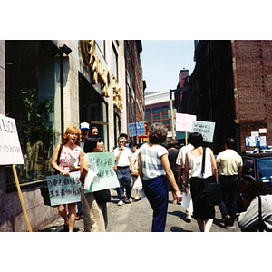 Demonstrators picket outside Dynasty Restaurant demanding back wages for workers