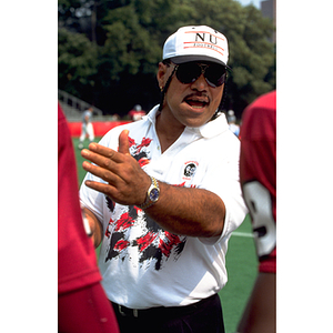 Football coach giving instructions to players at practice