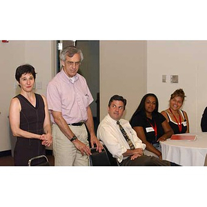 Sally Solomon and a man stand behind chairs at the Torch Scholars Orientation