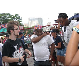 Three Torch Scholars stand outside Fenway Park