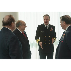 Vice Admiral Mark Fitzgerald speaks with three other men at the Veterans Memorial dedication ceremony