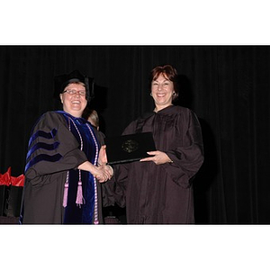 Faculty member presents student with award at School of Nursing convocation