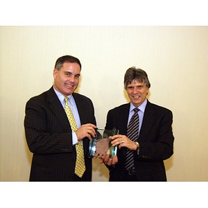 Dr. Ira. R. Weiss, right, presents Joseph Malarny, CBA '82, with the College of Business Administration's Distinguished Service Award