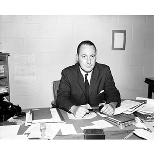 Dean of Criminal Justice Charles Tenney sits at his desk