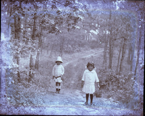 Two girls walking in the woods, Mashpee, Mass.