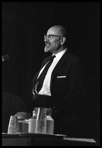 Isaac Deutscher, speaking at the National Teach-in on the Vietnam War: half-length portrait, standing at the podium