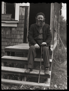 Charles Coffin, The Maine Hermit, seated on steps, with cane and pipe