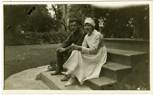 Lawrence D. Yeomans, in uniform, seated on steps with unidentified nurse