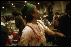 Cambodian New Year's celebration: drummer taking money in his teeth