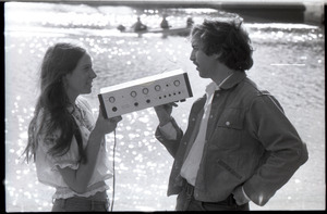 Lacey Mason and Elliot Blinder holding stereo equipment